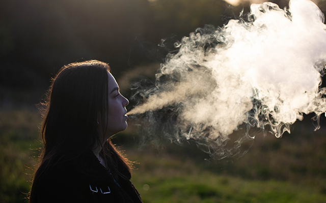 Smoke coming out of woman's mouth